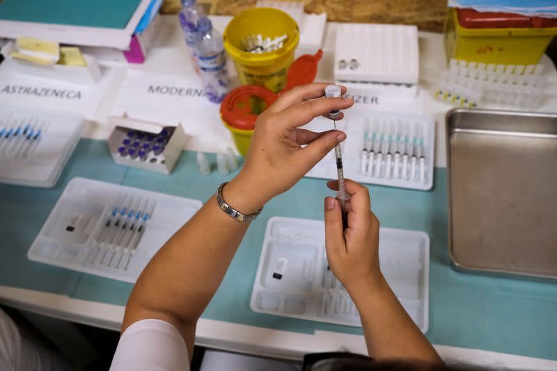 Healthcare worker prepares COVID-19 vaccine at a vaccination centre in Seixal