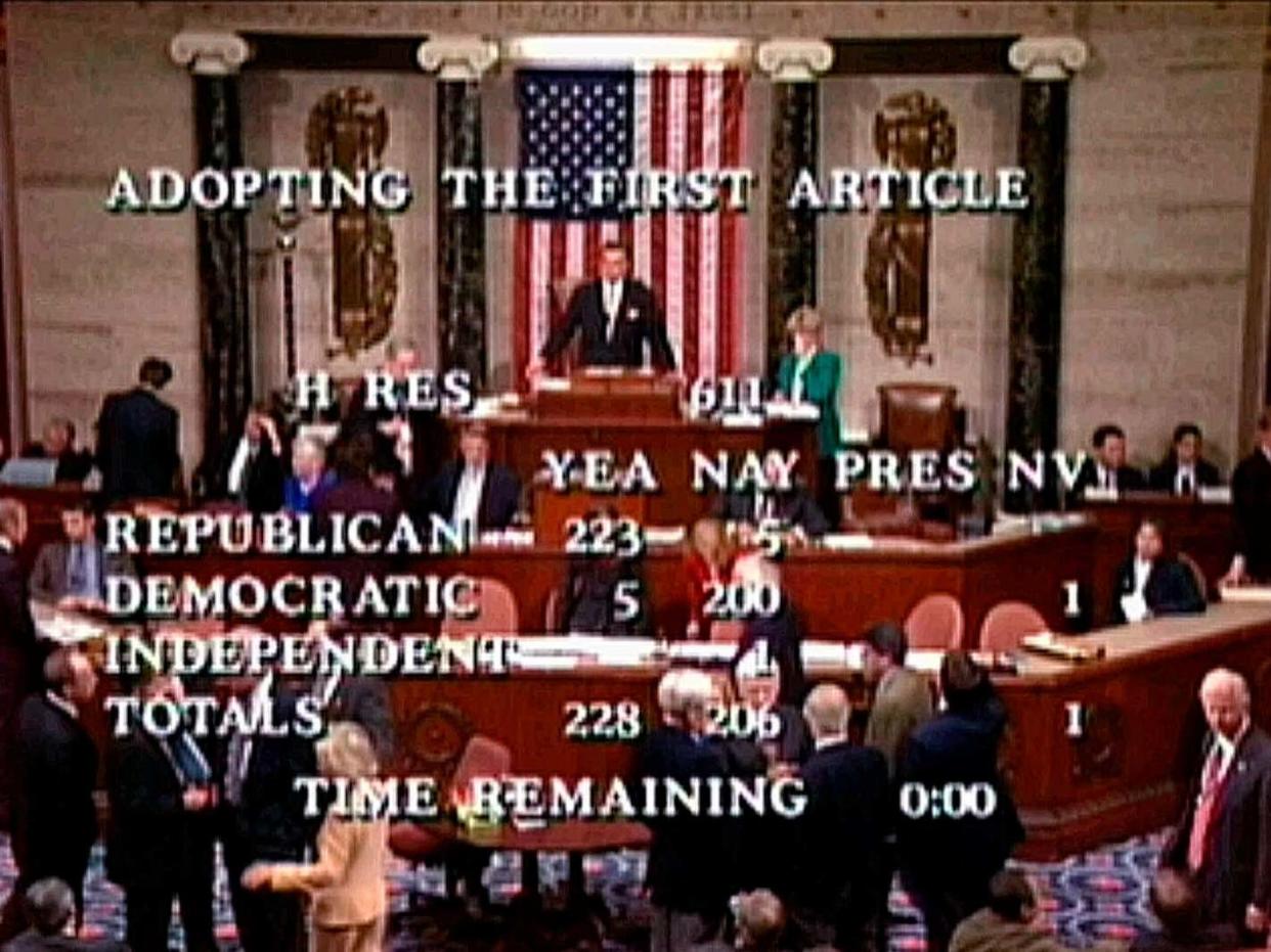 In this 19 December 1998 file image from video, speaker pro tempore Ray LaHood prepares to announce the House vote of 228-206 to approve the first article of impeachment, accusing president Bill Clinton of committing perjury before a federal grand jury in Washington (AP)