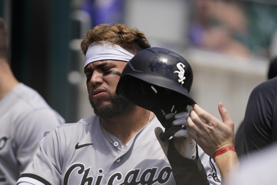 Chicago White Sox's Yoan Moncada walks into the dugout after scoring during the fourth inning of a baseball game against the Detroit Tigers, Sunday, June 13, 2021, in Detroit. (AP Photo/Carlos Osorio)