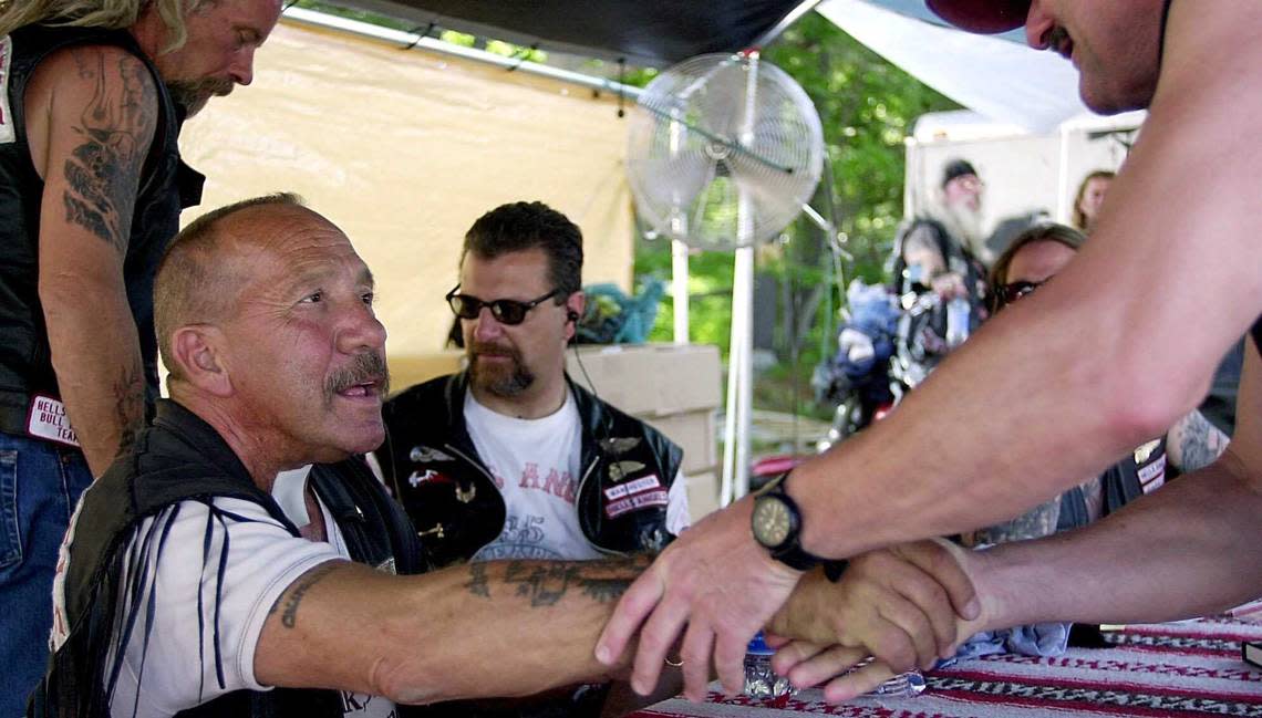 Hells Angels founder Sonny Barger, left, talks with customers at a Hells Angels booth at the Weirs Beach Drive-in in Laconia, N.H., in 2001. Barger will be memorialized Saturday in Stockton.