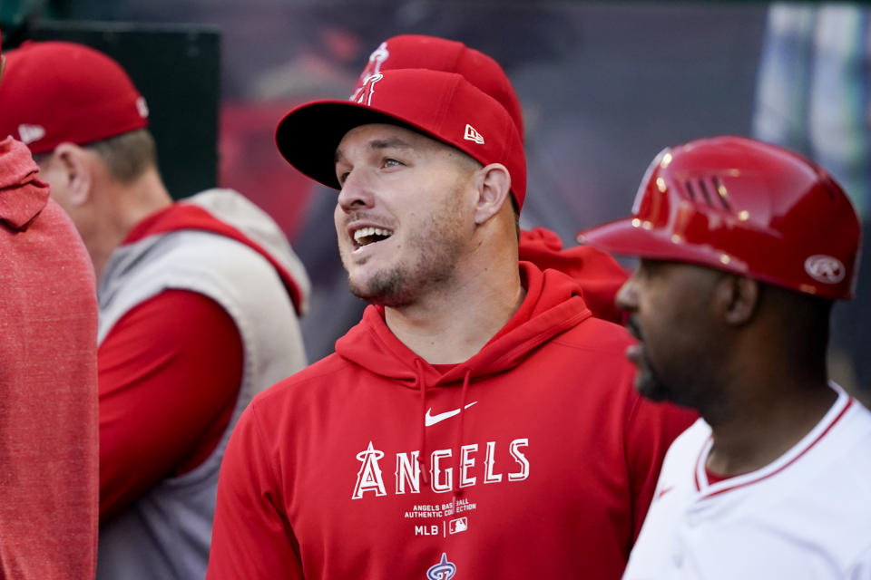 Los Angeles Angels center fielder Mike Trout speaks with teammates in the dugout before a baseball game against the Philadelphia Phillies, Tuesday, April 30, 2024, in Anaheim, Calif. (AP Photo/Ryan Sun)