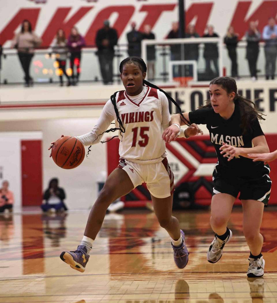 Princeton guard Solè Williams (15) drives to the basket against Mason's Anna Habra (31) during the OHSAA Division I regional tournament game Tuesday, Feb. 28, 2023.