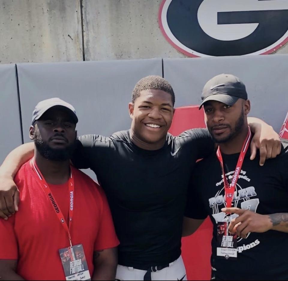 Harold Nelson (left) and Russell Ellington (right) with Nolan Smith after a UGA football game.