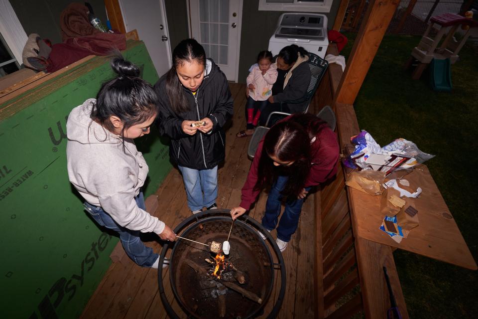 After Belen Hernandez, her daughter and younger sisters play outside, they prepare s'mores on April 10, 2024.