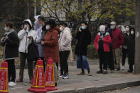 Residents line up for COVID tests in Beijing, Thursday, Nov. 24, 2022. China is expanding lockdowns, including in a central city where factory workers clashed this week with police, as its number of COVID-19 cases hit a daily record. (AP Photo/Ng Han Guan)