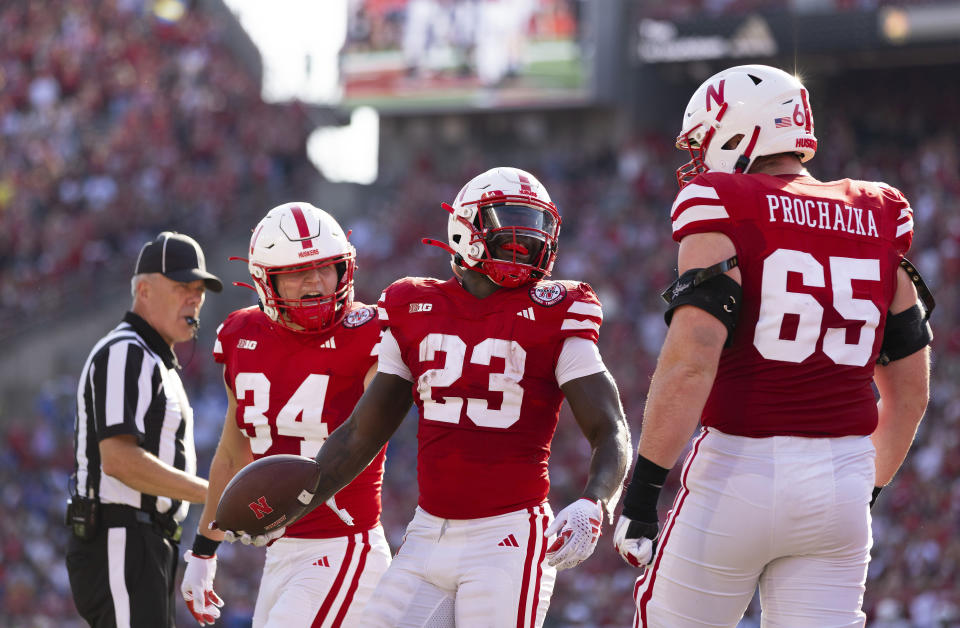 Nebraska's Anthony Grant (23) celebrates after scoring a touchdown with Barret Liebentritt (34) and Teddy Prochazka (65) against Louisiana Tech during the second half of an NCAA college football game, Saturday, Sept. 23, 2023, in Lincoln, Neb. (AP Photo/Rebecca S. Gratz)