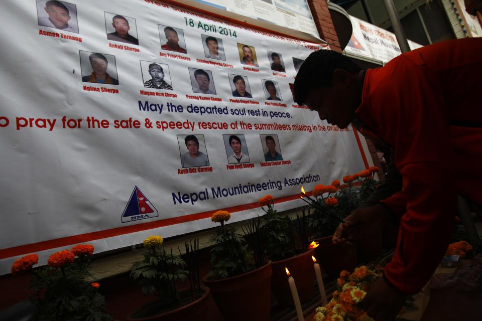 A Nepalese climber lights incense during a memorial service for the 16 Nepalese Sherpa guides killed in avalanche on Mount Everest in Katmandu, Nepal, Wednesday, April 30, 2014. The April 18 avalanche was the deadliest disaster on the world's highest mountain. (AP Photo/Niranjan Shrestha)
