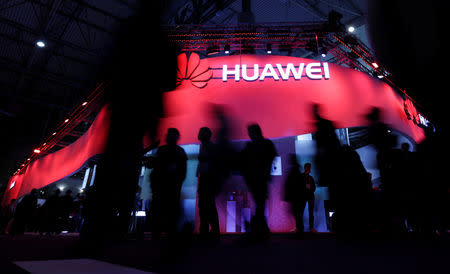 FILE PHOTO - Visitors walk past Huawei's booth during Mobile World Congress in Barcelona, Spain, February 27, 2017. REUTERS/Eric Gaillard/File Photo