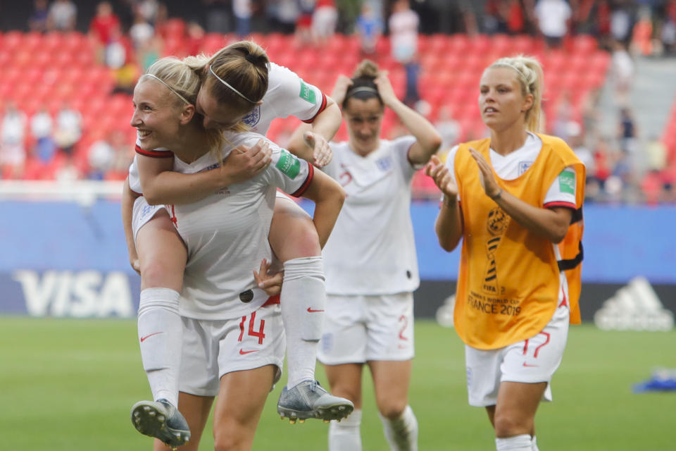 England players celebrate at the end of the Women's World Cup round of 16 soccer match between England and Cameroon at the Stade du Hainaut stadium in Valenciennes, France, Sunday, June 23, 2019. England beat Cameroon 3-0. (AP Photo/Michel Spingler)