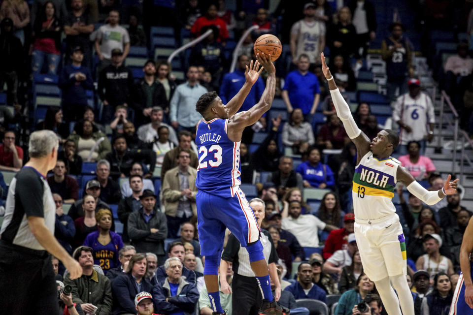 Philadelphia 76ers guard Jimmy Butler (23) shoots over New Orleans Pelicans forward Cheick Diallo (13) in the second half of an NBA basketball game in New Orleans, Monday, Feb. 25, 2019. The 76ers won 111-110. (AP Photo/Scott Threlkeld)