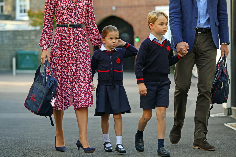 Britain's Princess Charlotte of Cambridge, with her brother, Britain's Prince George of Cambridge, arrives for her first day of school at Thomas's Battersea in London on September 5, 2019. 