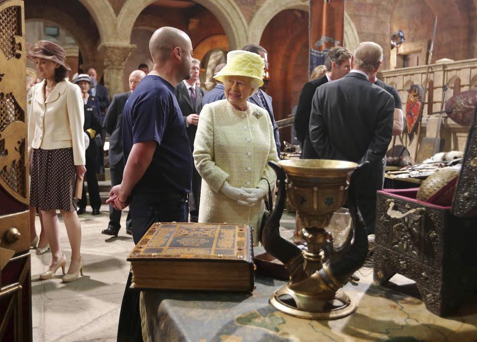 Britain's Queen Elizabeth looks at props as she visits the set of TV series Game of Thrones, in Belfast