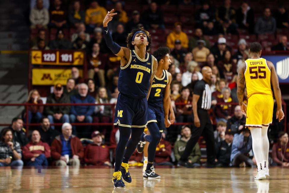 Dug McDaniel (0) of the Michigan Wolverines celebrates his basket against the Minnesota Golden Gophers in the first half of the game at Williams Arena on December 8, 2022 in Minneapolis, Minnesota.