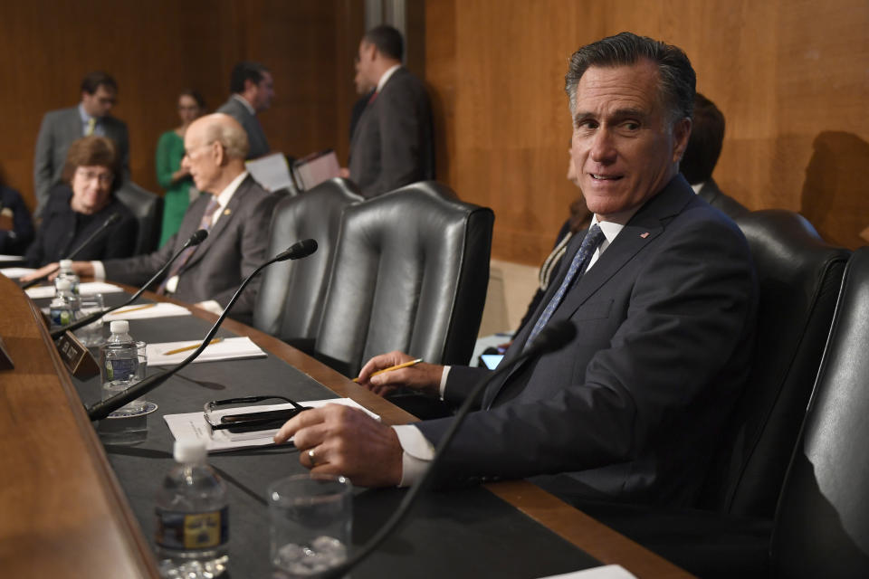 Sen. Mitt Romney, R-Utah, talks with a colleague during a break in an executive session of the Senate Health, Education, Labor and Pensions Committee on Capitol Hill in Washington, Tuesday, Sept. 24, 2019. The committee voted to advance Scalia's nomination to the full Senate for consideration. (AP Photo/Susan Walsh)