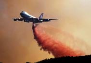 FILE PHOTO: An Evergreen 747 Supertanker makes a drop in the Acton area in California