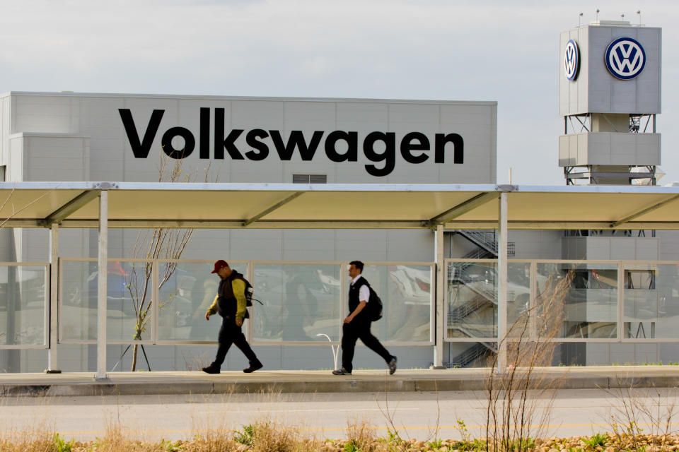 FILE - In this March 21, 2012, file photo, workers walk by the Volkswagen AG plant in Chattanooga, Tenn. Workers at the plant will decide in a three-day vote Wednesday, Feb. 12, 2014, whether they want to be represented by the United Auto Workers union. (AP Photo/Erik Schelzig, file)