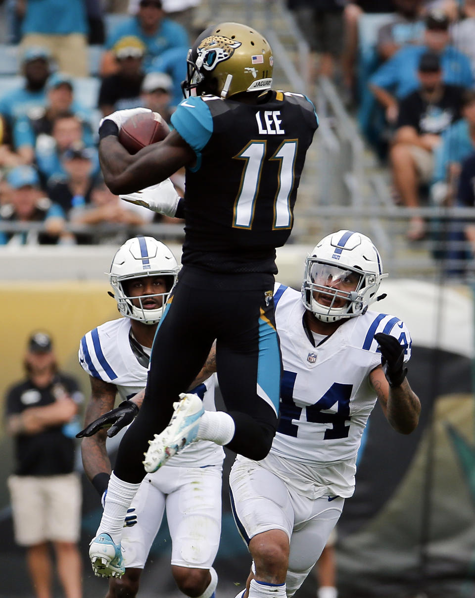 <p>Jacksonville Jaguars wide receiver Marqise Lee (11) makes a reception in front of Indianapolis Colts safety T.J. Green, left, and inside linebacker Antonio Morrison (44) during the first half of an NFL football game, Sunday, Dec. 3, 2017, in Jacksonville, Fla. (AP Photo/Stephen B. Morton) </p>