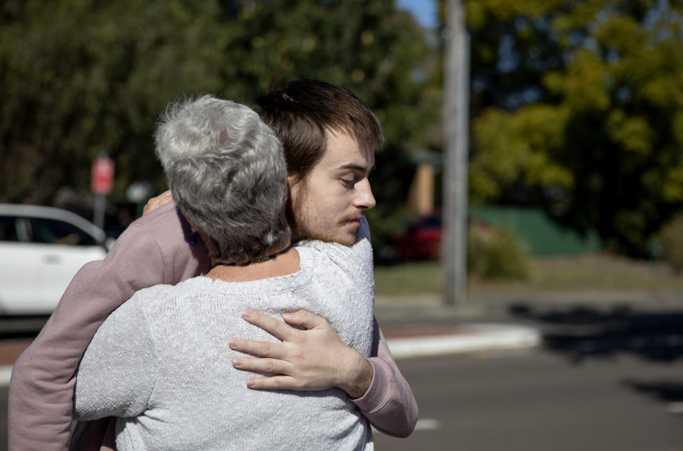Sam Ware, 22, hugs his mother, Deb, after seeing her for the first time since his last overdose in Fountaindale, Central Coast, Australia, Friday, July 19, 2019. It's been three weeks since he cut Deb off. He says he's been staying in a hostel, but has no money left, no place to go. He says he can stay clean, if only he had a roof over his head. (AP Photo/David Goldman)