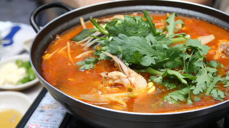Fish soup in black pot 