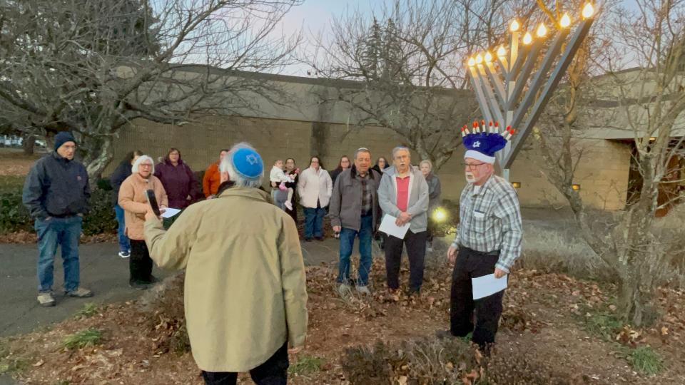 Beth Jacob Synagogue Rabbi Julius Rabinowitz (in front) leads the congregation during a menorah lighting ceremony on Thursday, the last day of Hanukkah this year.