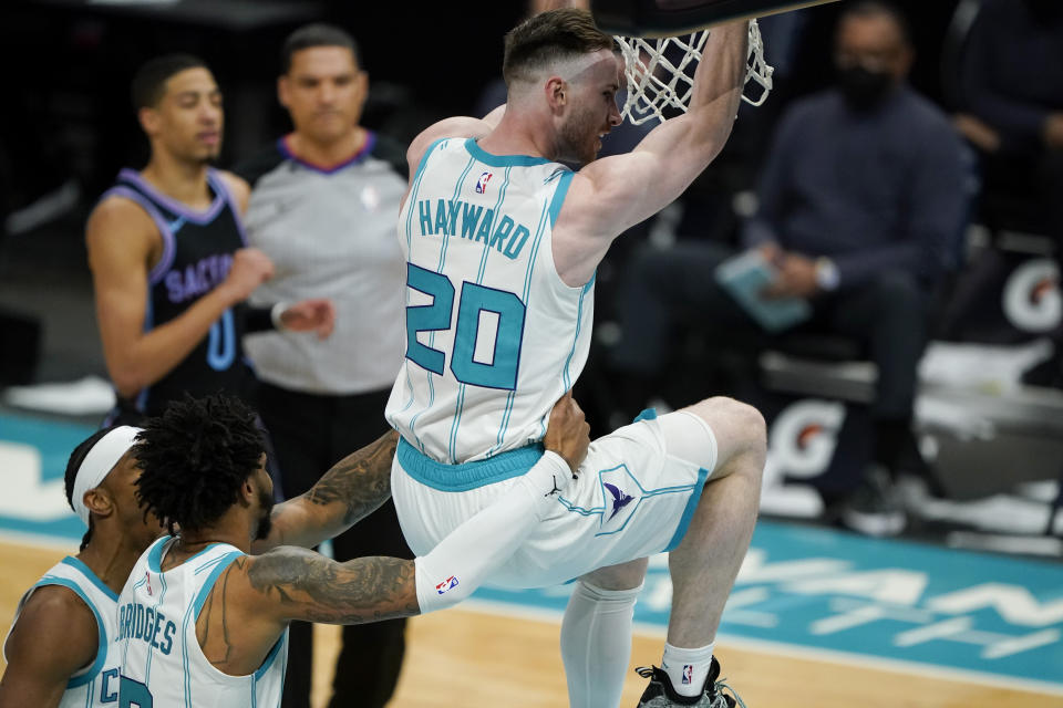 Charlotte Hornets forward Gordon Hayward celebrates after scoring with forward Miles Bridges during the second half of an NBA basketball game against the Sacramento Kings on Monday, March 15, 2021, in Charlotte, N.C. (AP Photo/Chris Carlson)