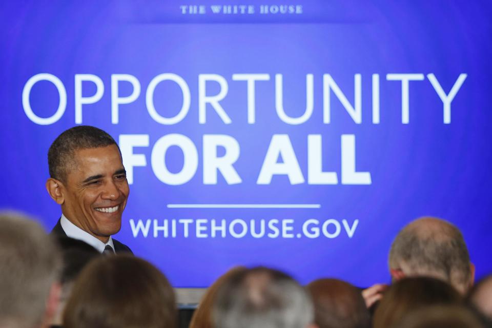 President Barack Obama smiles at audience members after he spoke about efforts to help the long term unemployed during an event in the East Room at the White House in Washington, Friday, Jan. 31, 2014. (AP Photo/Charles Dharapak)