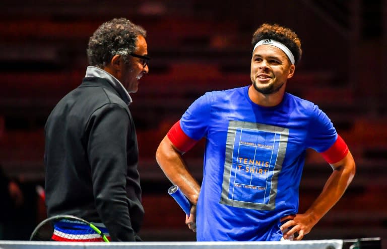 France's tennis player Jo-Wilfried Tsonga (R) speaks with team captain Yannick Noah during a training session in Villeneuve d'Ascq on November 22, 2017, ahead of their Davis Cup World Group final against Belgium