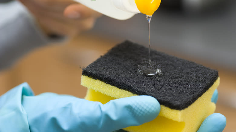 Pouring dish soap onto sponge