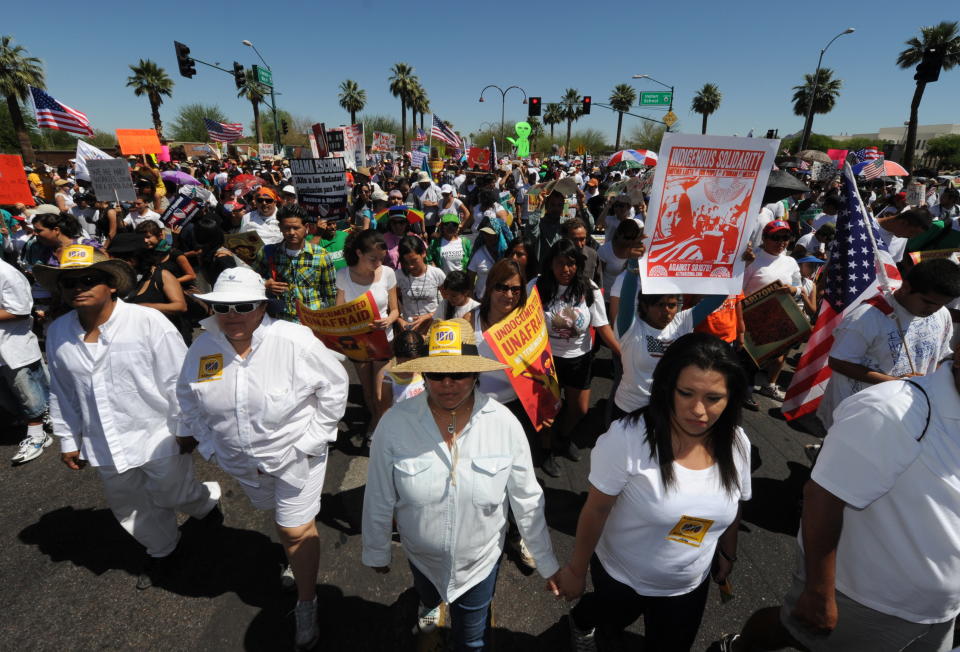 A mass of protesters demonstrate against Arizona's tough new immigration laws at a large rally in Phoenix on May 29, 2010.  Rights groups had already announced plans to file a legal challenge to the law, which makes it a state crime to lack proper immigration papers and requires police to determine whether people were in the country legally. Activists say the law will open the door to racial profiling by police, but supporters point to wording of the bill that expressly forbids law enforcement from stopping someone on the basis of their ethnicity. Arizona Governor Jan Brewer has said the law, which has attracted broad support according to recent opinion polls, is needed to help secure the state's porous border, one of the main entry points for illegal immigrants in the US.         AFP PHOTO/Mark RALSTON (Photo credit should read MARK RALSTON/AFP/Getty Images)