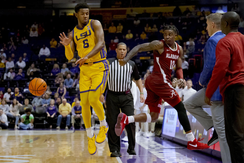 Alabama guard Latrell Wrightsell Jr. (12) keeps the ball in bounds as passes past LSU guard Jordan Wright (6) during the second half of an NCAA college basketball game in Baton Rouge, La., Saturday, Feb. 10, 2024. (AP Photo/Matthew Hinton)