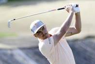 Rickie Fowler follows through on the fourth tee during the final round of The American Express golf tournament on the Stadium Course at PGA West in La Quinta, Calif., Sunday, Jan. 19, 2020. (AP Photo/Alex Gallardo)