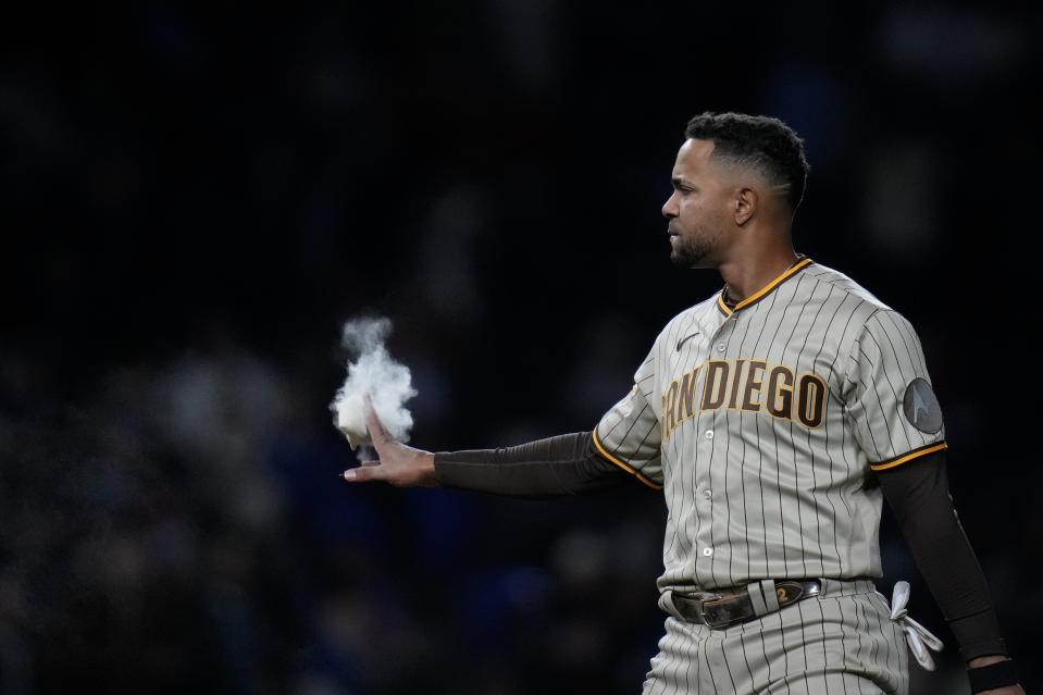 San Diego Padres' Xander Bogaerts slaps the pitcher's rosin bag after striking out during the sixth inning of the team's baseball game against the Chicago Cubs on Tuesday, April 25, 2023, in Chicago. (AP Photo/Erin Hooley)