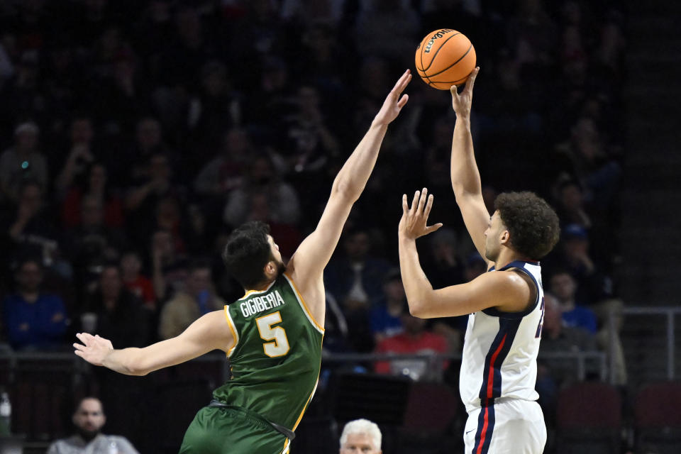 Gonzaga forward Anton Watson, right, shoots against San Francisco center Saba Gigiberia (5) during the first half of an NCAA college basketball game in the semifinals of the West Coast Conference men's tournament Monday, March 6, 2023, in Las Vegas. (AP Photo/David Becker)