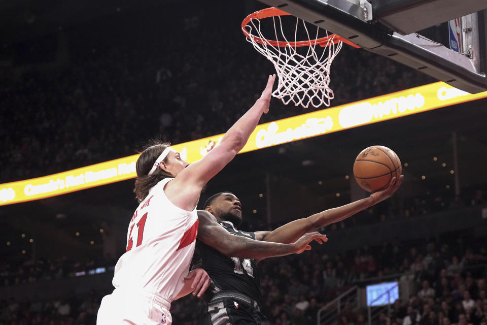 San Antonio Spurs' Blake Wesley, right, shoots against Toronto Raptors' Kelly Olynyk, left, during first-half NBA basketball game action in Toronto, Monday Feb. 12, 2024. (Chris Young/The Canadian Press via AP)