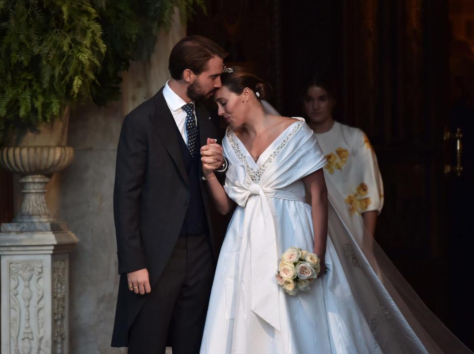 Prince Philippos and Princess Nina of Greece on their wedding day in 2021. The bride wears a white Chanel gown.