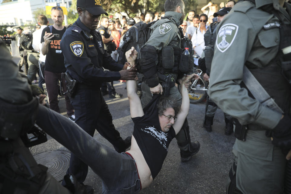 Police arrest a a man during a protest in Tel Aviv, Israel, Wednesday, July 3, 2019. Israeli police were bracing for another day of violent protests Wednesday after community activists called for renewed street demonstrations in response to the killing of an Ethiopian-Israeli teen by an off-duty police officer. (AP Photo/Oded Balilty)