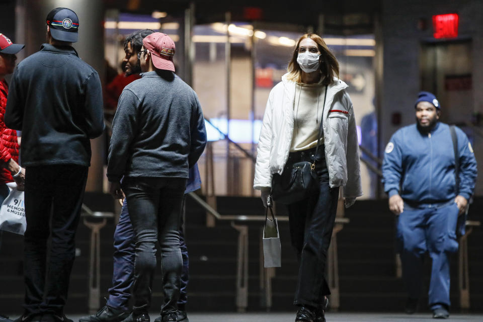 A commuter wears a face mask in the New York City transit system, Monday, March 9, 2020, in New York. New York continued grappling Monday with the new coronavirus, as case numbers, school closings and other consequences grew. (AP Photo/John Minchillo)