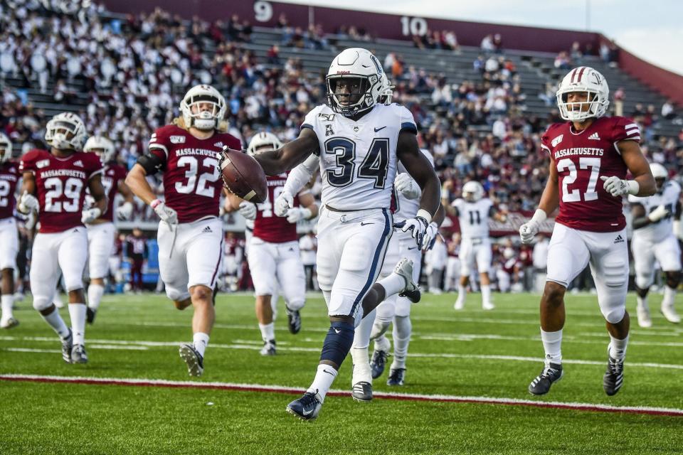 UConn's Kevin Mensah enters the end zone for his first of five touchdowns during the Huskies' 56-35 win over UMass in 2019 at Amherst, Mass.