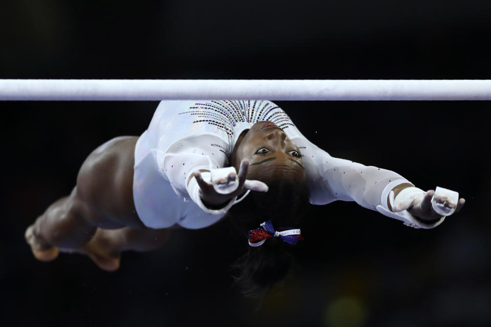 Simone Biles of the United States performs on the uneven bars during a warmup for the women's all-around final at the Gymnastics World Championships in Stuttgart, Germany, on Oct. 10, 2019. (AP Photo/Matthias Schrader)