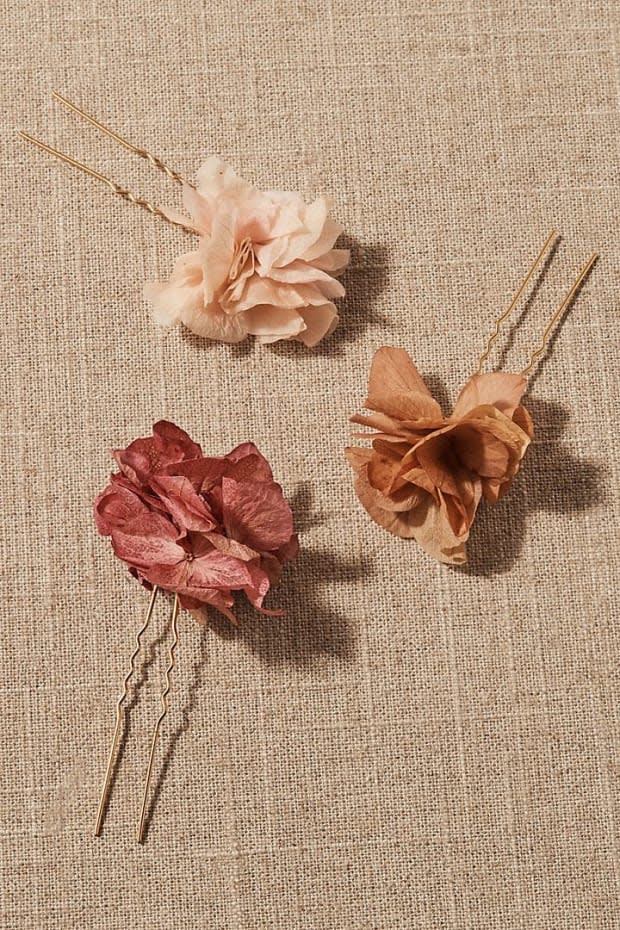 <p>Daphne Preserved Flower Hair Pin Set, $138, <a href="https://rstyle.me/+_E0TT1fWW6pxCL3lnNleYA" rel="nofollow noopener" target="_blank" data-ylk="slk:available here;elm:context_link;itc:0;sec:content-canvas" class="link ">available here</a>.</p>