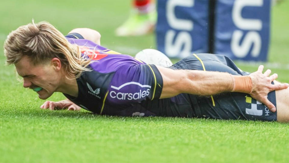 Pictured here, Melbourne's Ryan Papenhuyzen clutches at his hamstring in the game against the Dragons.