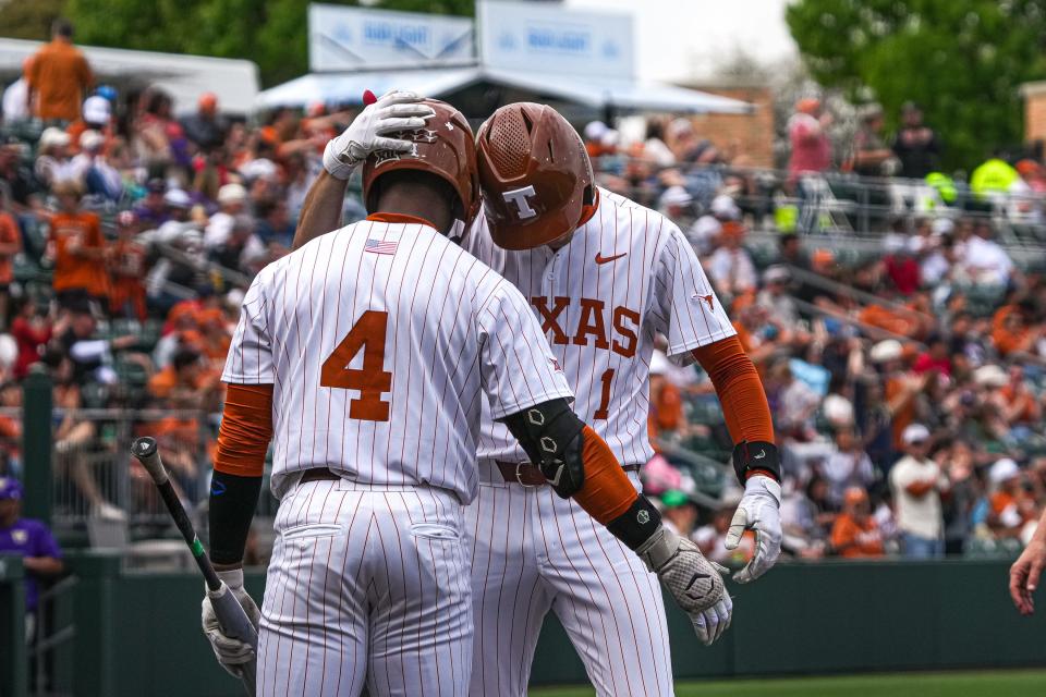 Texas outfielder Porter Brown, front, celebrates a home run hit by shortstop Jalin Flores during Saturday's 5-3 loss to Washington at UFCU Disch-Falk Field. It was the second straight loss to the Huskies.