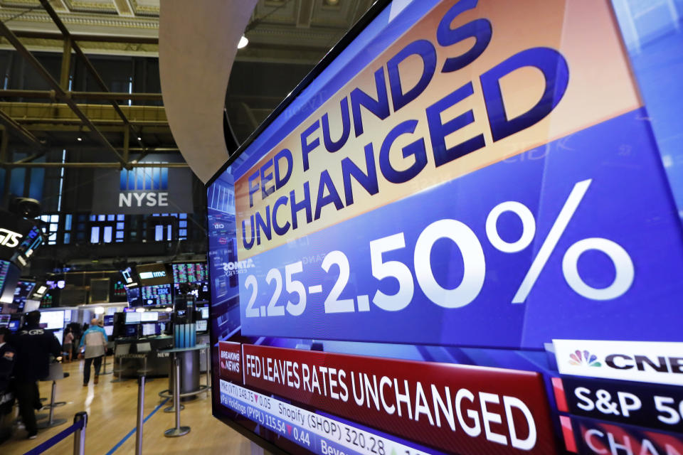 A television screen on the trading floor of the New York Stock Exchange shows the rate decision of the Federal Reserve, Wednesday, June 19, 2019. The Federal Reserve is leaving its key interest rate unchanged but signaling that it's prepared to start cutting rates if needed to protect the U.S. economy from trade conflicts and other threats. (AP Photo/Richard Drew)