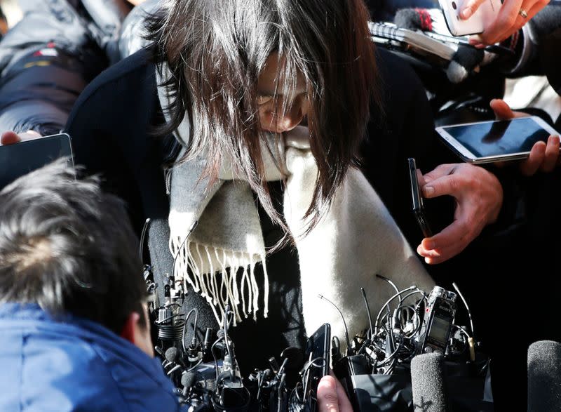 Heather Cho, daughter of chairman of Korean Air Lines, Cho Yang-ho, is surrounded by media upon her arrival at the Seoul Western District Prosecutor's Office in Seoul