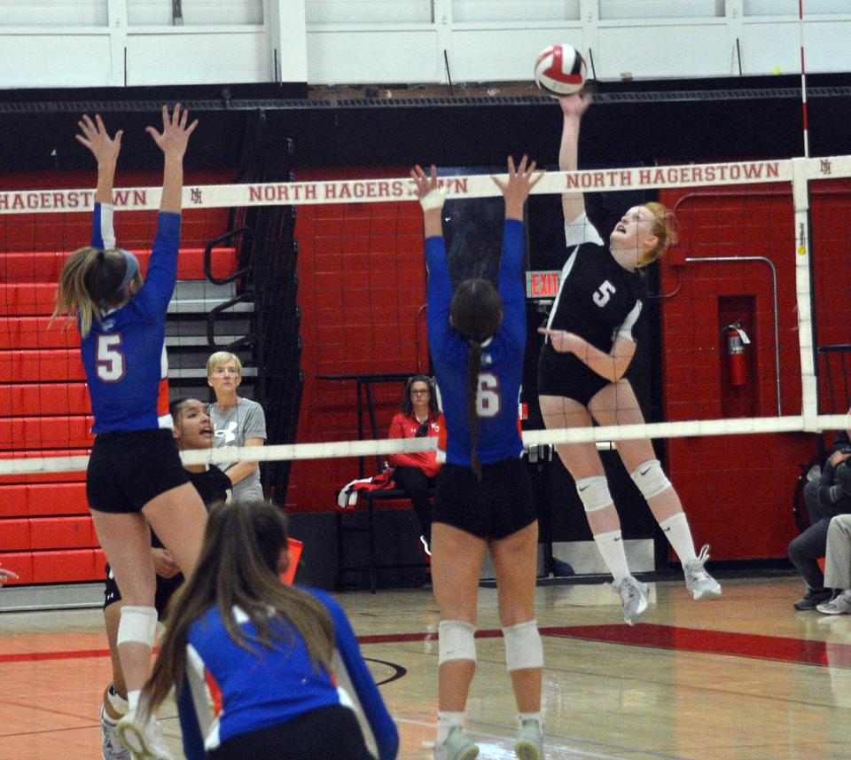 North Hagerstown's Baylee Doolan (5) hits a kill attempt as Boonsboro's Hannah Culver (5) and Delaney Long (6) put up a double block during a volleyball match at North on Oct. 18, 2022.