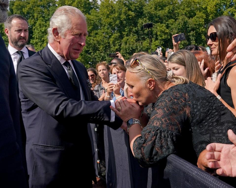 A well-wisher kisses the hand of King Charles III (Yui Mok/PA) (PA Wire)