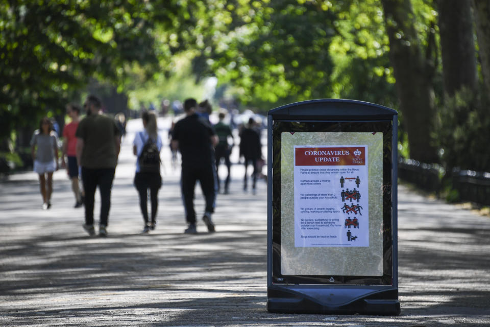 A social distancing sign is seen at the entrance of Regent's Park, as the lockdown continues due to the coronavirus outbreak, in London, Sunday, April 26, 2020. The public have been asked to self isolate, keeping distant from others to limit the spread of the contagious COVID-19 coronavirus.(AP Photo/Alberto Pezzali)