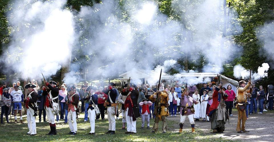 Militia and mountain men line up and fire a round of gunshots to kick off Yankee Peddler at Clay's Resort Jellystone Park in Lawrence Township.