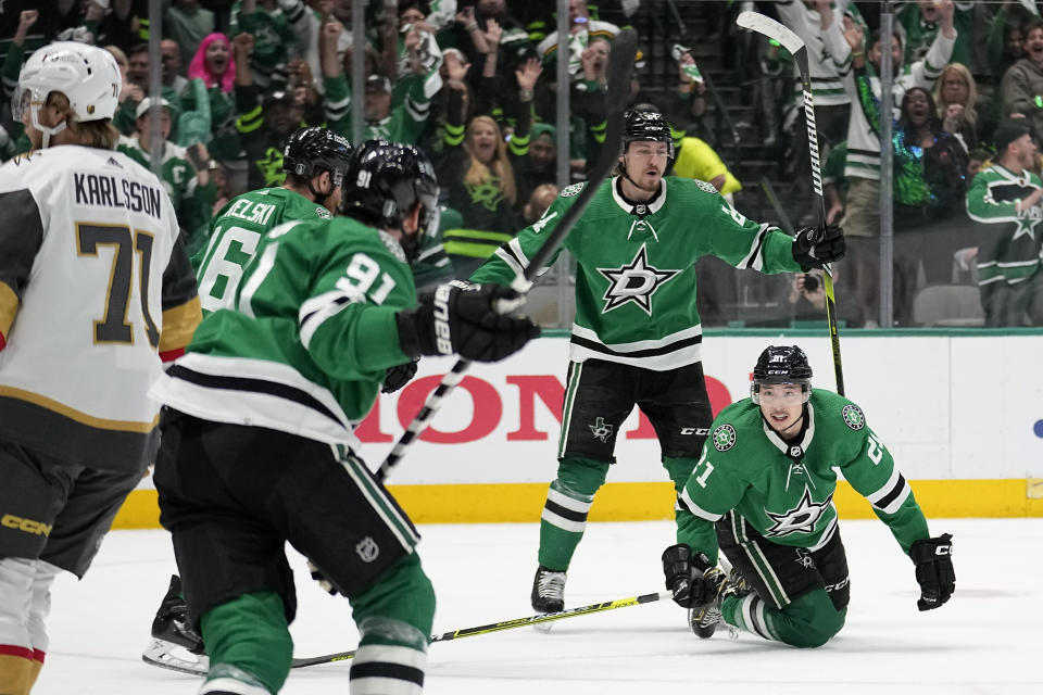 Dallas Stars left wing Jason Robertson (21) falls to the ice after scoring against the Vegas Golden Knights, as Tyler Seguin (91), Joe Pavelski (16) and Roope Hintz (24) celebrate during the the first period of Game 4 of the NHL hockey Stanley Cup Western Conference finals Thursday, May 25, 2023, in Dallas. Golden Knights' William Karlsson (71) skates past the celebration. (AP Photo/Tony Gutierrez)