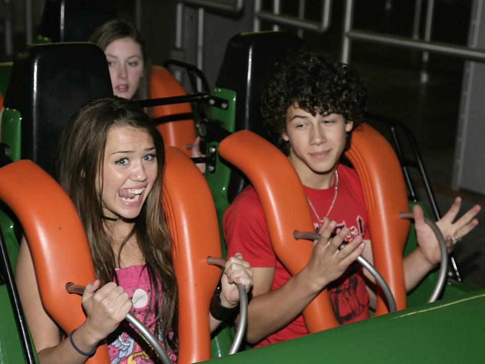 Miley Cyrus and Nick Jonas on a roller coaster.